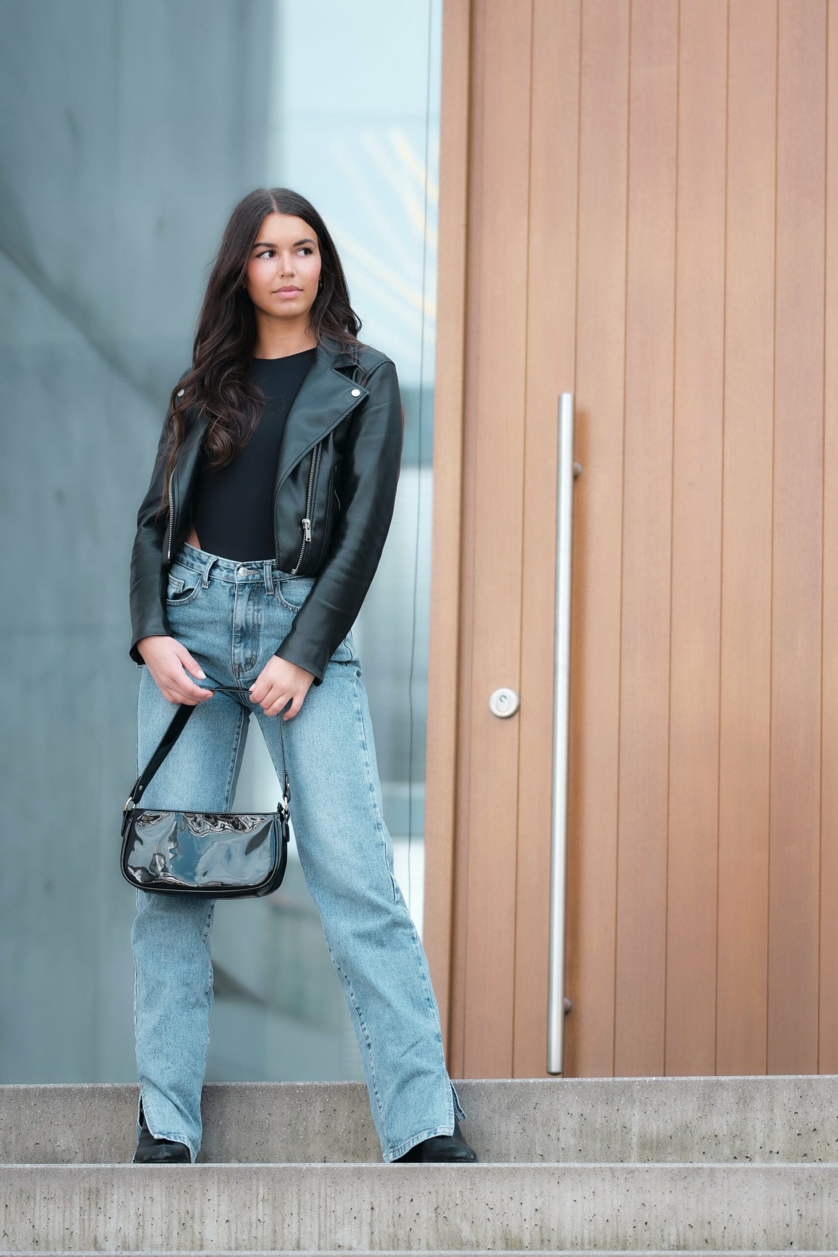 Woman wearing straight leg jeans with motorcycle jacket