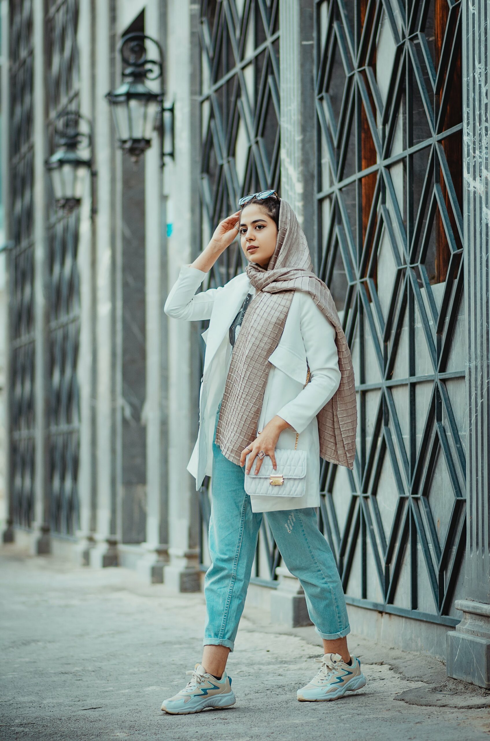 Woman wearing scarf and light wash jeans