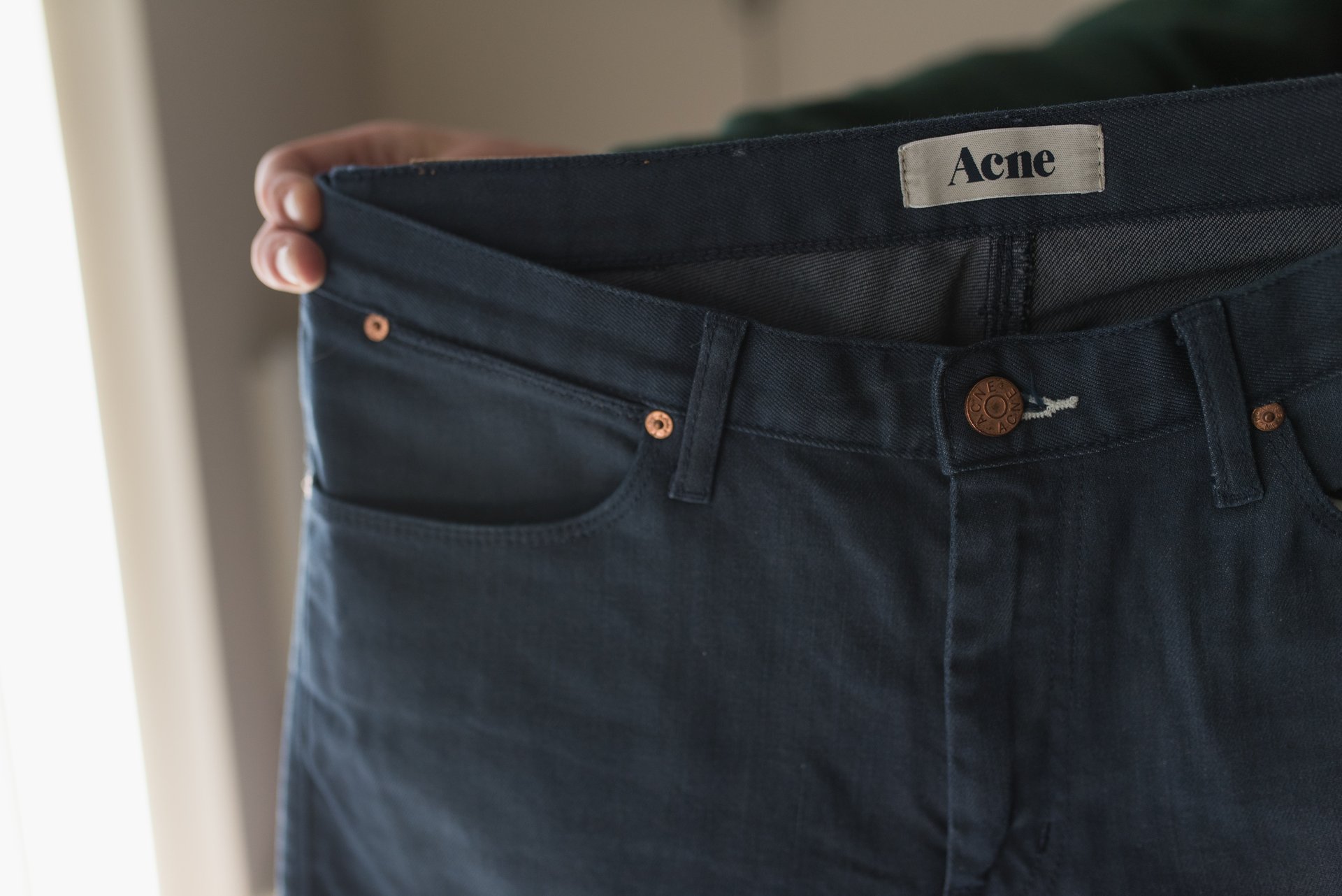 Woman trying how to unshrink jeans with stretching