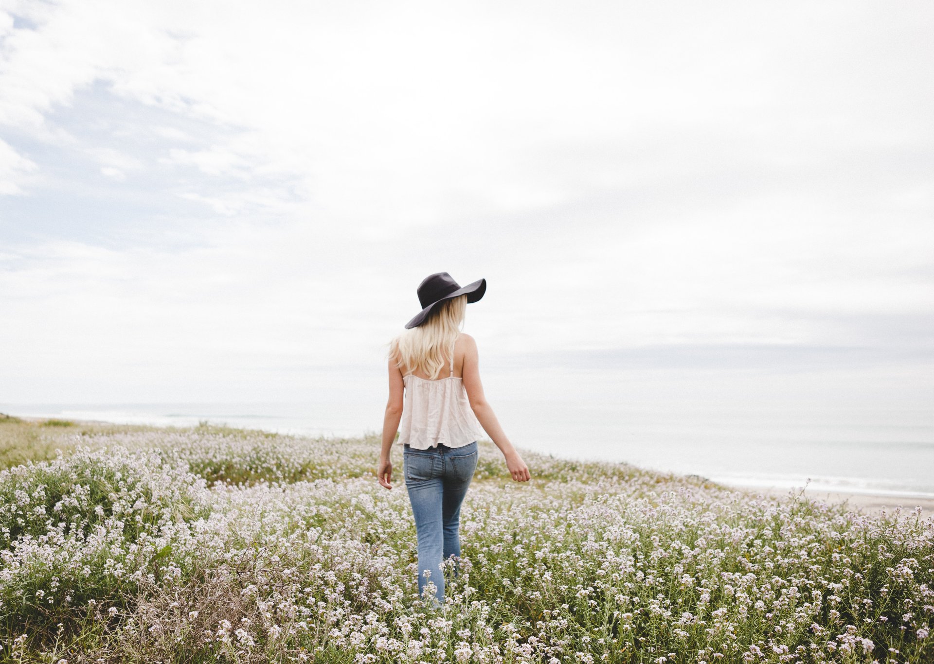 How to wear jeans in the summer - woman wearing hat and sleeveless top