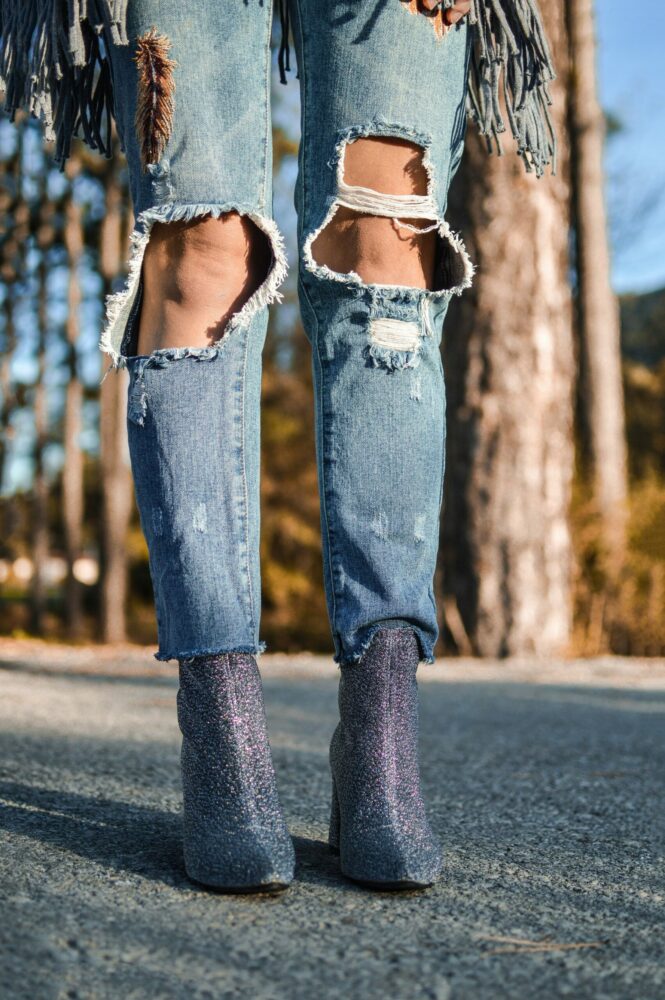 Woman wearing ripped jeans and booties