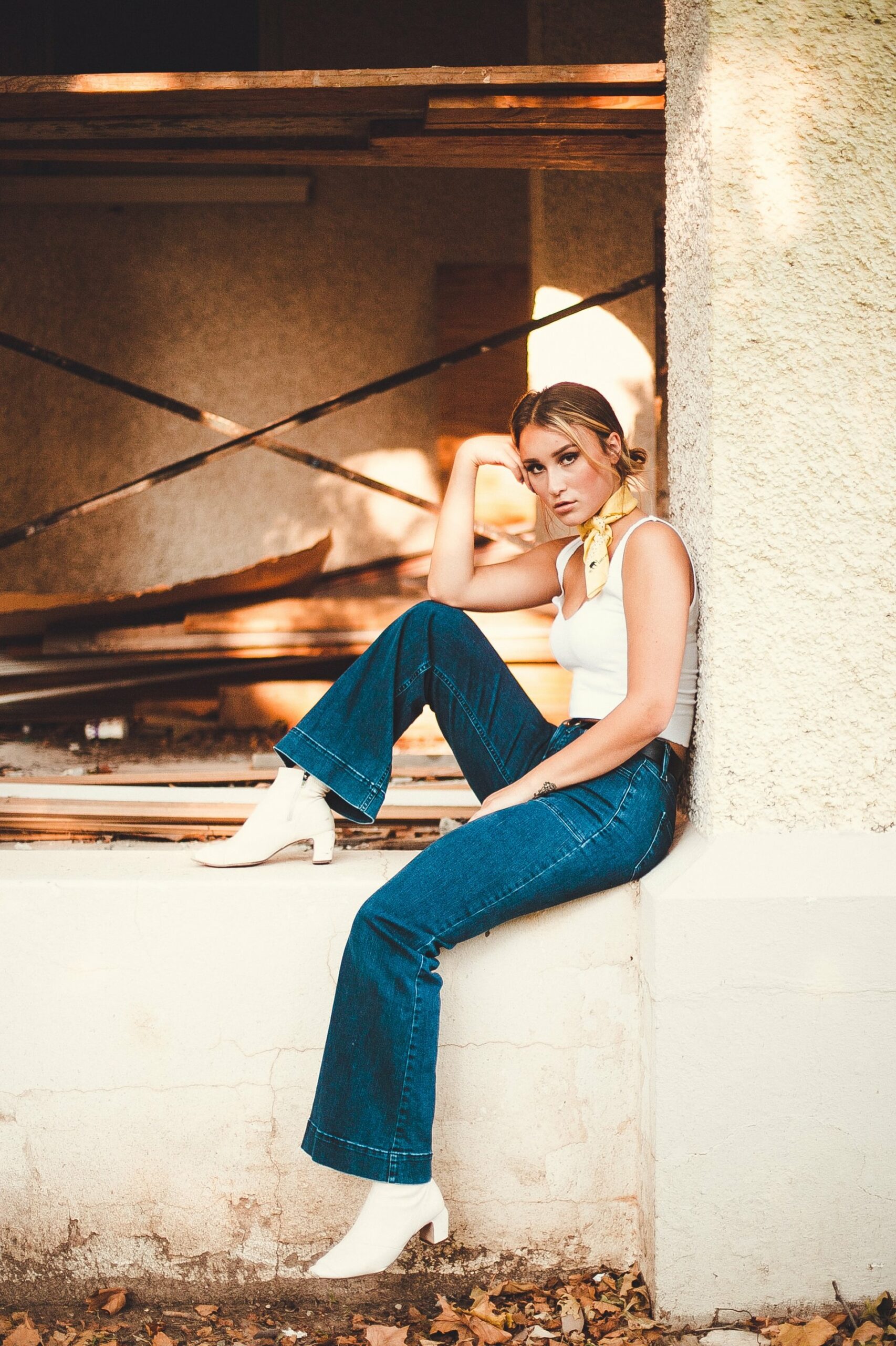 Woman wearing white top and bootcut jeans