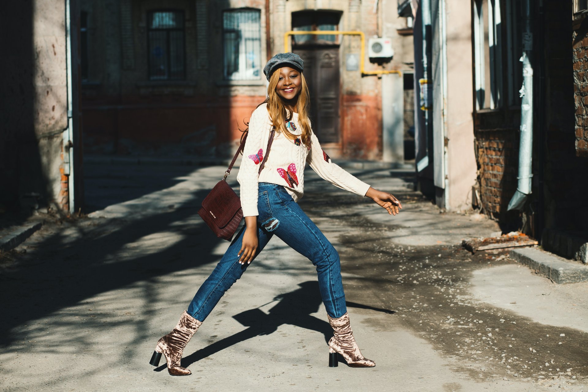 Woman wearing sweater and slim fit jeans