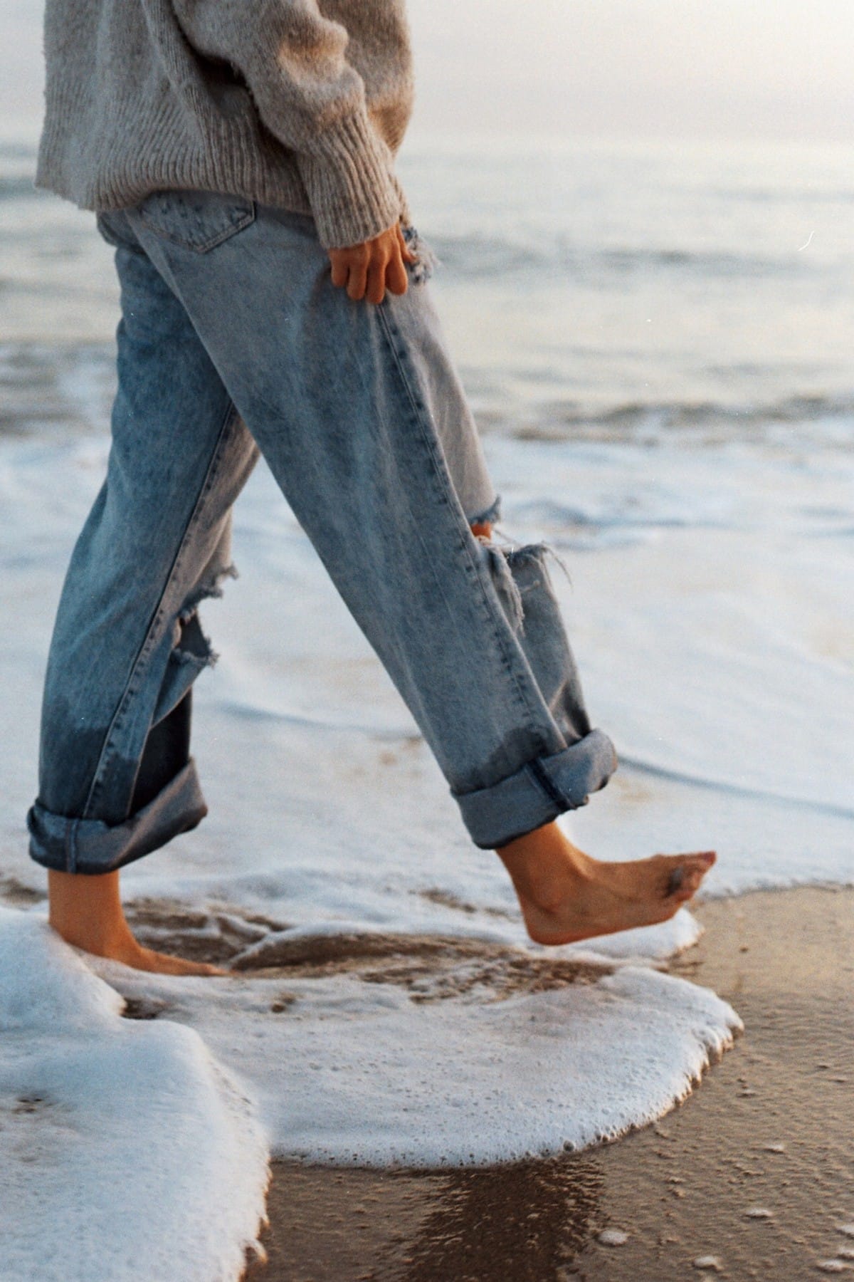 Woman wearing dad jeans on the beach